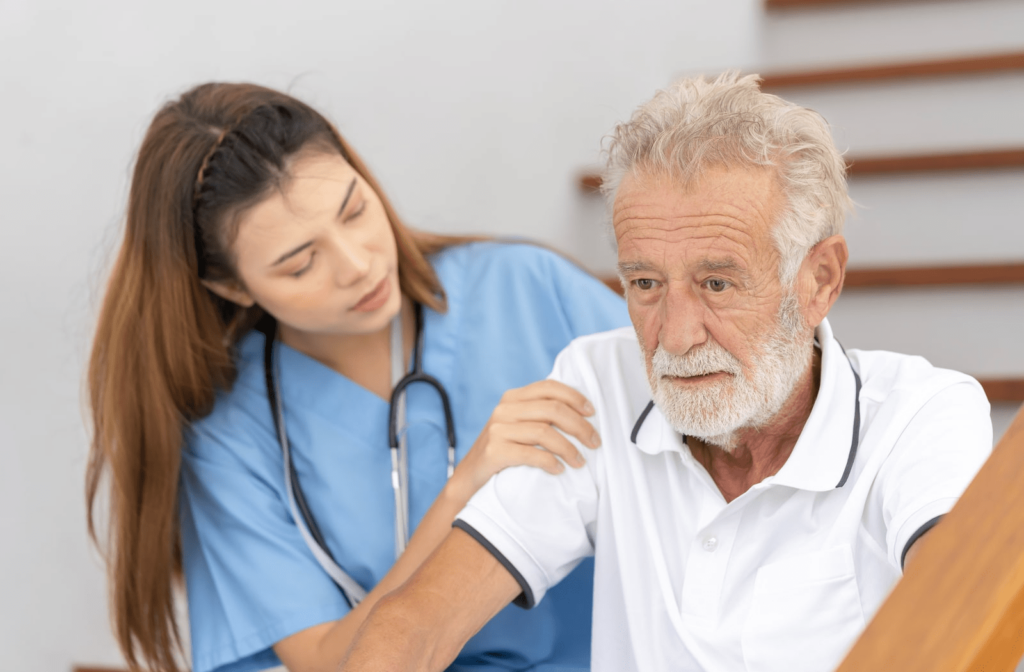 A female nurse helping a male patient with Alzheimer's disease