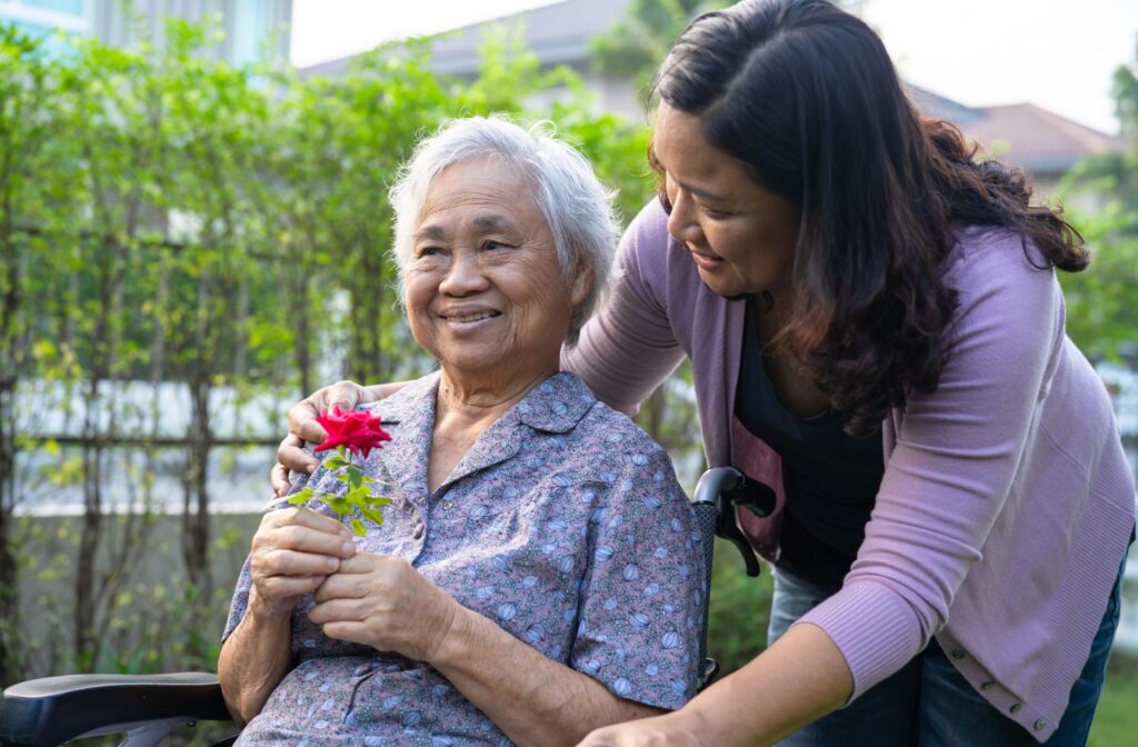 A nurse gives a memory care resident a small cat and some cat toys as a means of cognitive enrichment