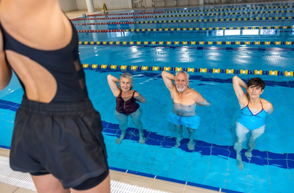 Three older adults work out together to stay fit and make class more fun.